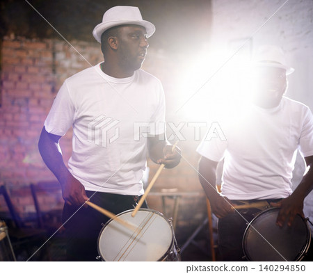 Man, drums and band playing with instrument at festival, carnival or party together with lens flare. Male person, talented drummer or young group of musicians at night concert or music event in Rio Man, drums and band playing with instrument at festival, carnival or party together with lens flare. Male person, talented drummer or young group of musicians at night concert or music event in Rio 140294850
