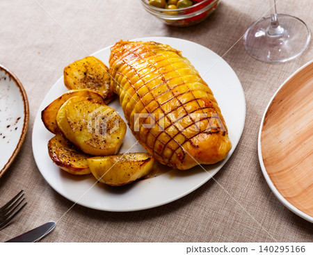 Stuffed chicken served with potatoes on platter Stuffed chicken served with potatoes on platter 140295166