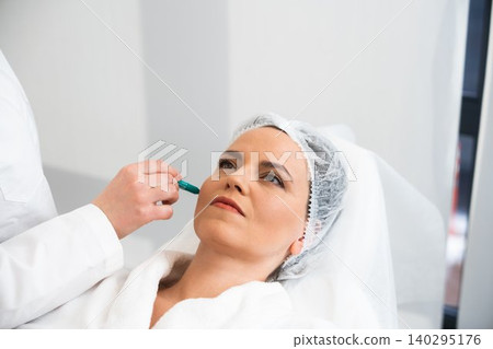 Woman receiving a cosmetic treatment in a modern clinic setting 140295176