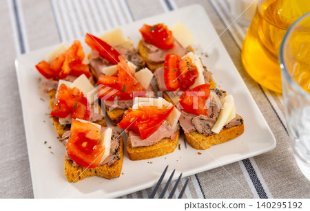 There are sandwiches canape with pate, cheese and tomato on plate. There are sandwiches canape with pate, cheese and tomato on plate. 140295192