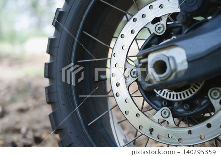 Motorcycle Brake Disc And Off Road Wheel Closeup Motorcycle Brake Disc And Off Road Wheel Closeup 140295359
