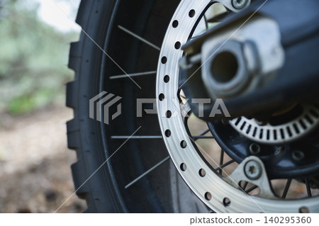 Motorcycle Brake Disc And Off Road Wheel Closeup Motorcycle Brake Disc And Off Road Wheel Closeup 140295360