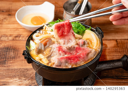 Sukiyaki: A traditional Japanese hot pot dish enjoyed with a sweet and savory broth. Sukiyaki: A traditional Japanese hot pot dish enjoyed with a sweet and savory broth. 140295363