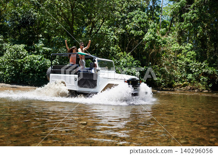 Couple, forest and adventure with 4x4, river and outdoor with love, care or nature with drive in summer. People, man and woman for splash in vehicle, car or journey on road trip in jungle in Colombia Couple, forest and adventure with 4x4, river and outdoor with love, care or nature with drive in summer. People, man and woman for splash in vehicle, car or journey on road trip in jungle in Colombia 140296056