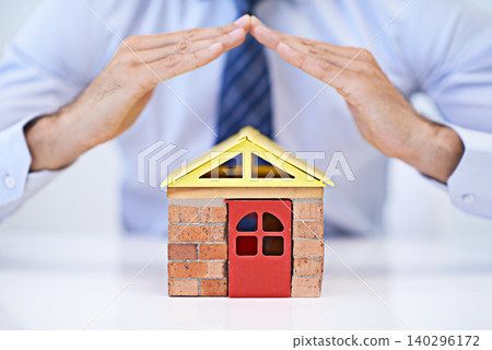 Businessman, architect and house model for home insurance, design and professional workspace. Male person, realtor and confident for idea, office and protection for mortgage bond in real estate Businessman, architect and house model for home insurance, design and professional workspace. Male person, realtor and confident for idea, office and protection for mortgage bond in real estate 140296172