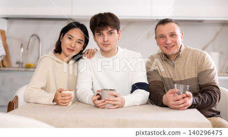 Adult man and sitting at table in kitchen Adult man and sitting at table in kitchen 140296475