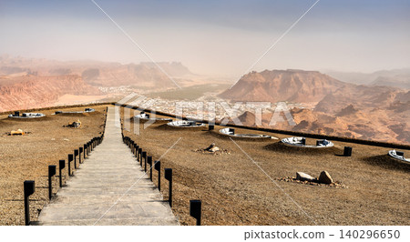 A wide landscape view of the Al-Ula valley and surrounding mountains from the Harrat Viewpoint observation deck in Saudi Arabia A wide landscape view of the Al-Ula valley and surrounding mountains from the Harrat Viewpoint observation deck in Saudi Arabia 140296650