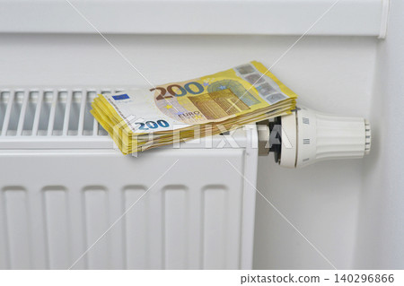 Stack of 200 euro banknotes on thermostat - concept of high energy cost, heating expenses, inflation, and economic crisis for finance, and energy themes 140296866