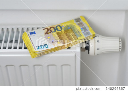 Stack of 200 euro banknotes on thermostat - concept of high energy cost, heating expenses, inflation, and economic crisis for finance, and energy themes Stack of 200 euro banknotes on thermostat - concept of high energy cost, heating expenses, inflation, and economic crisis for finance, and energy themes 140296867