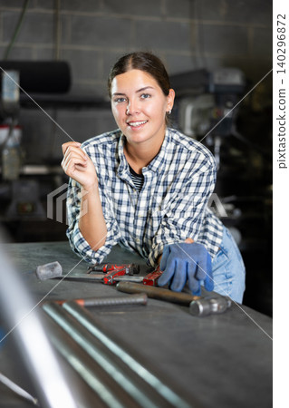 Young woman posing in metallurgical workshop 140296872