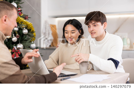 young woman and guy discussing deal with agent young woman and guy discussing deal with agent 140297079