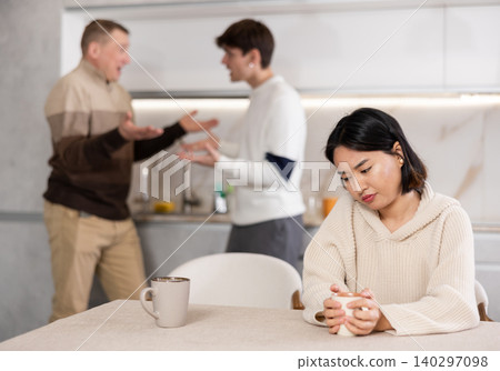Young woman sad during family quarrel Young woman sad during family quarrel 140297098