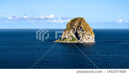 A picturesque view of the iconic Diamond Rock volcanic islet surrounded by the deep blue waters of the Caribbean Sea off the coast of Martinique, France A picturesque view of the iconic Diamond Rock volcanic islet surrounded by the deep blue waters of the Caribbean Sea off the coast of Martinique, France 140297489