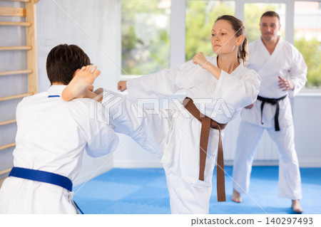 Man and woman train to perform basic defensive attacking actions during mortal techniques classes Man and woman train to perform basic defensive attacking actions during mortal techniques classes 140297493
