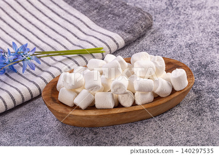 Fluffy White Marshmallows in Wooden Bowl, Blue Flowers, Striped Fabric Fluffy White Marshmallows in Wooden Bowl, Blue Flowers, Striped Fabric 140297535