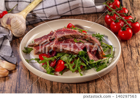 Sliced beef steak with fresh arugula and cherry tomatoes on plate Sliced beef steak with fresh arugula and cherry tomatoes on plate 140297563