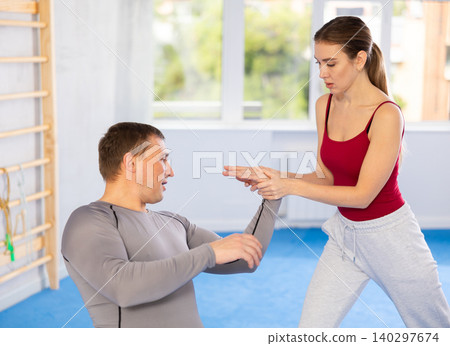 Woman and man practicing self defense techniques Woman and man practicing self defense techniques 140297674