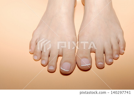 Well groomed female feet with french pedicure Well groomed female feet with french pedicure 140297741