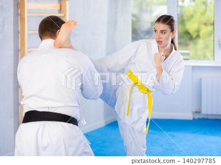 Woman and man in kimono exercising 140297785