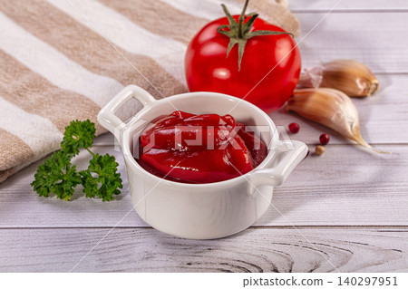 Tomato ketchup in white bowl with fresh ingredients like tomato, garlic, and parsley on wooden table Tomato ketchup in white bowl with fresh ingredients like tomato, garlic, and parsley on wooden table 140297951