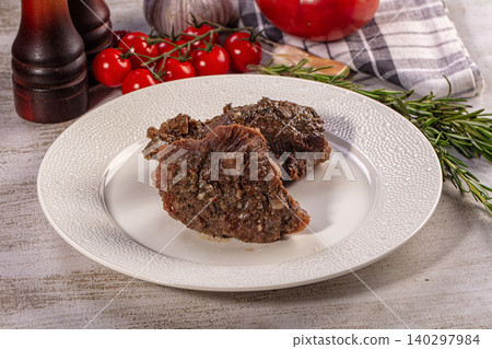 Delicious Beef Cheek Serving with Rosemary and Tomatoes on Rustic Table Delicious Beef Cheek Serving with Rosemary and Tomatoes on Rustic Table 140297984