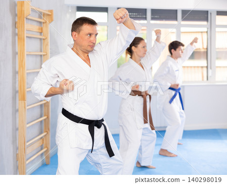 Athletes have starting position and repeating sequence of punches and painful techniques in kata Athletes have starting position and repeating sequence of punches and painful techniques in kata 140298019