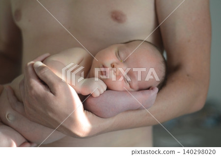 Newborn baby sleeping on forearm of father. Newborn baby sleeping on forearm of father. 140298020