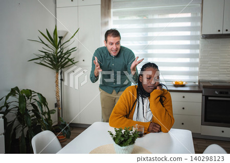 Interracial couple having serious argument in home kitchen Interracial couple having serious argument in home kitchen 140298123