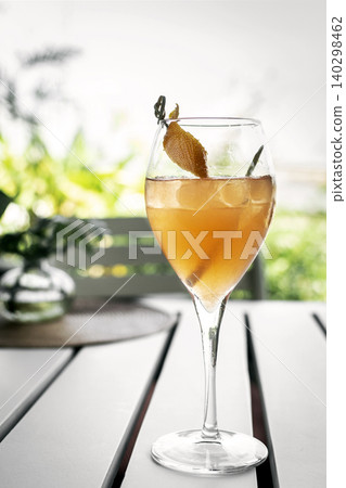 screwdriver vodka and orange cocktail in wine glass on white table in outdoor garden restaurant screwdriver vodka and orange cocktail in wine glass on white table in outdoor garden restaurant 140298462