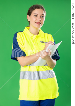 Young woman manager in reflective polo filling papers 140298529