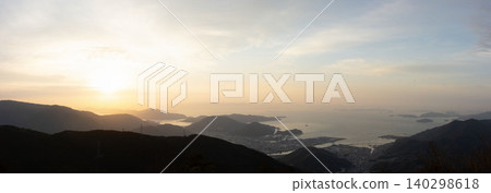 The beautiful sunset sinking behind the islands of the Seto Inland Sea, and the twilight view of Kure Port from Mt. Haigamine. The beautiful sunset sinking behind the islands of the Seto Inland Sea, and the twilight view of Kure Port from Mt. Haigamine. 140298618