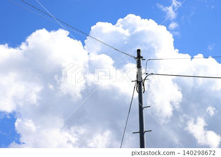 A blue sky with clouds and a telephone pole A blue sky with clouds and a telephone pole 140298672