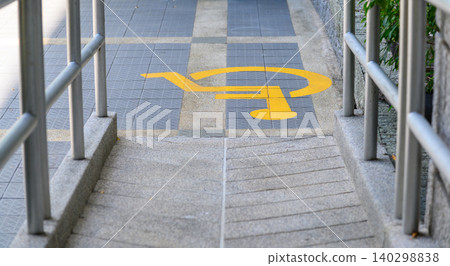 Yellow painted handicapped sign traffic symbol on the floor in front of ramp way for support wheelchair Yellow painted handicapped sign traffic symbol on the floor in front of ramp way for support wheelchair 140298838