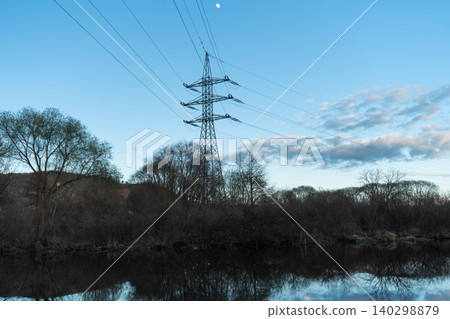 Electric Power Tower Above Riverside Trees Electric Power Tower Above Riverside Trees 140298879
