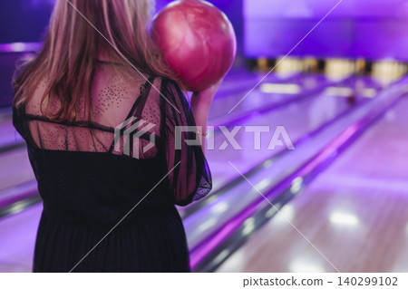 Bowling club play, group team of friends and colleagues playing, throwing a ball on the bowling alley lane, ball and pins, corporate party event in a mall amusement game center, tournament competition Bowling club play, group team of friends and colleagues playing, throwing a ball on the bowling alley lane, ball and pins, corporate party event in a mall amusement game center, tournament competition 140299102