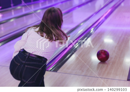 Bowling club play, group team of friends and colleagues playing, throwing a ball on the bowling alley lane, ball and pins, corporate party event in a mall amusement game center, tournament competition Bowling club play, group team of friends and colleagues playing, throwing a ball on the bowling alley lane, ball and pins, corporate party event in a mall amusement game center, tournament competition 140299103
