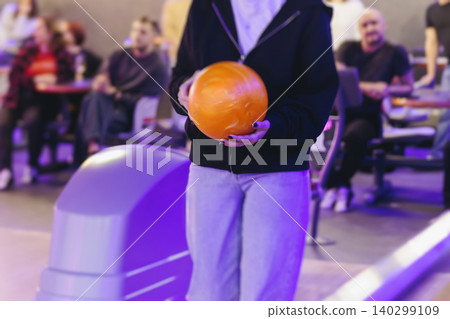 Bowling club play, group team of friends and colleagues playing, throwing a ball on the bowling alley lane, ball and pins, corporate party event in a mall amusement game center, tournament competition Bowling club play, group team of friends and colleagues playing, throwing a ball on the bowling alley lane, ball and pins, corporate party event in a mall amusement game center, tournament competition 140299109