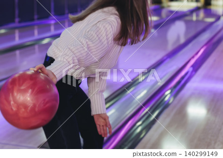 Bowling club play, group team of friends and colleagues playing, throwing a ball on the bowling alley lane, ball and pins, corporate party event in a mall amusement game center, tournament competition Bowling club play, group team of friends and colleagues playing, throwing a ball on the bowling alley lane, ball and pins, corporate party event in a mall amusement game center, tournament competition 140299149