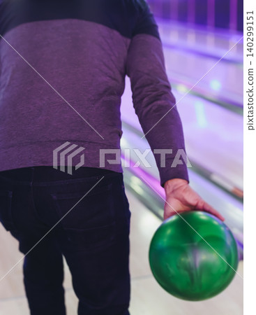 Bowling club play, group team of friends and colleagues playing, throwing a ball on the bowling alley lane, ball and pins, corporate party event in a mall amusement game center, tournament competition Bowling club play, group team of friends and colleagues playing, throwing a ball on the bowling alley lane, ball and pins, corporate party event in a mall amusement game center, tournament competition 140299151