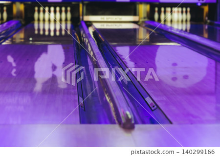 Bowling club play, group team of friends and colleagues playing, throwing a ball on the bowling alley lane, ball and pins, corporate party event in a mall amusement game center, tournament competition Bowling club play, group team of friends and colleagues playing, throwing a ball on the bowling alley lane, ball and pins, corporate party event in a mall amusement game center, tournament competition 140299166