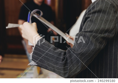 Process of checking in on conference congress forum event, registration desk table, visitors and attendees receiving lanyard with name badge and entry wristband bracelet and register electronic ticket 140299180