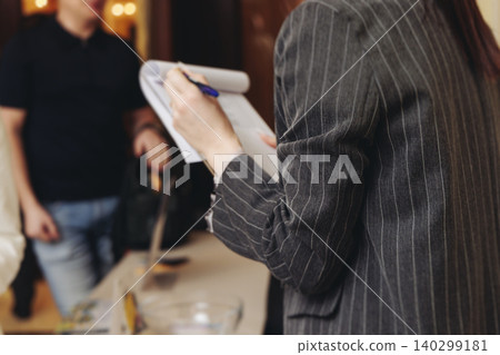 Process of checking in on conference congress forum event, registration desk table, visitors and attendees receiving lanyard with name badge and entry wristband bracelet and register electronic ticket 140299181
