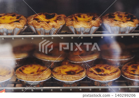 Pasteis and Pastel de nata, traditional Portuguese egg custard tart pasty cakes, dessert Pasteis de nata with different pastry in the cafe, bakery display window, Pastel de belem, Lisbon, Portugal 140299206