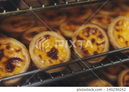 Pasteis and Pastel de nata, traditional Portuguese egg custard tart pasty cakes, dessert Pasteis de nata with different pastry in the cafe, bakery display window, Pastel de belem, Lisbon, Portugal Pasteis and Pastel de nata, traditional Portuguese egg custard tart pasty cakes, dessert Pasteis de nata with different pastry in the cafe, bakery display window, Pastel de belem, Lisbon, Portugal 140299262