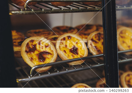 Pasteis and Pastel de nata, traditional Portuguese egg custard tart pasty cakes, dessert Pasteis de nata with different pastry in the cafe, bakery display window, Pastel de belem, Lisbon, Portugal 140299263