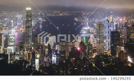 Hong Kong night evening view, China, seen from Victoria Peak observation deck, Lugard road lookout, with Hong Kong downtown skyscrapers and Kowloon island, illuminated city and Victoria Bay at night Hong Kong night evening view, China, seen from Victoria Peak observation deck, Lugard road lookout, with Hong Kong downtown skyscrapers and Kowloon island, illuminated city and Victoria Bay at night 140299293