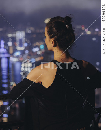 Hong Kong night evening view, China, seen from Victoria Peak observation deck, Lugard road lookout, with Hong Kong downtown skyscrapers and Kowloon island, illuminated city and Victoria Bay at night Hong Kong night evening view, China, seen from Victoria Peak observation deck, Lugard road lookout, with Hong Kong downtown skyscrapers and Kowloon island, illuminated city and Victoria Bay at night 140299308