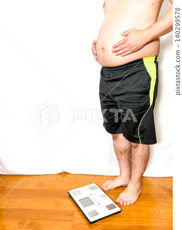 A middle-aged man who is overweight and concerned about his weight. 140299578