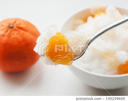 Shaved ice Kakigori granita fruit dessert for summer made of ice with juice sauce in bowl on table. Shaved ice Kakigori granita fruit dessert for summer made of ice with juice sauce in bowl on table. 140299600