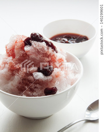 Shaved ice Kakigori granita berry dessert for summer made of ice with juice sauce in bowl on table. 140299601
